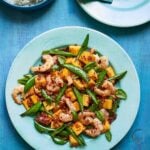 Sweet and spicy mango prawns stir-fry with sugarsnap peas and torn basil, served with jasmine rice